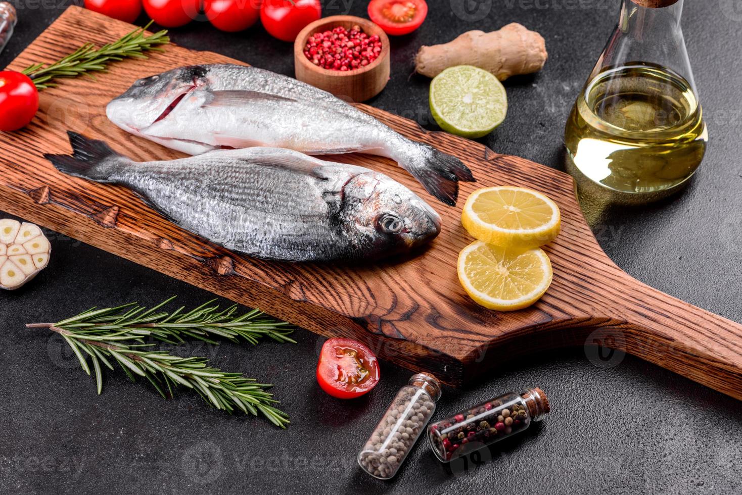 Raw dorado fish with spices cooking on cutting board photo