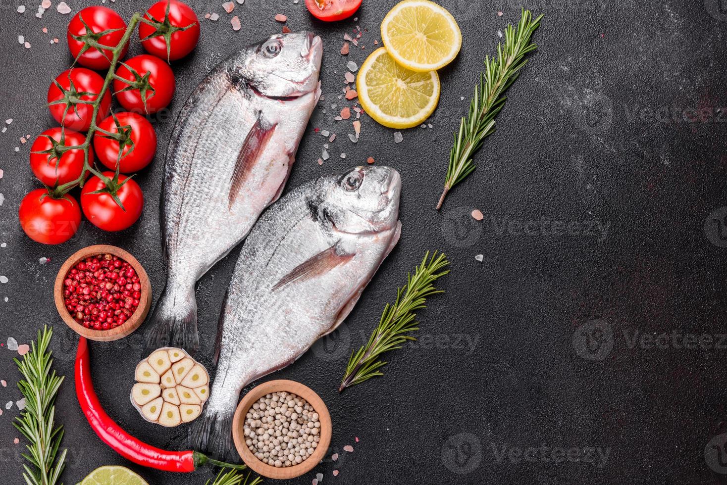 Raw dorado fish with spices cooking on cutting board photo