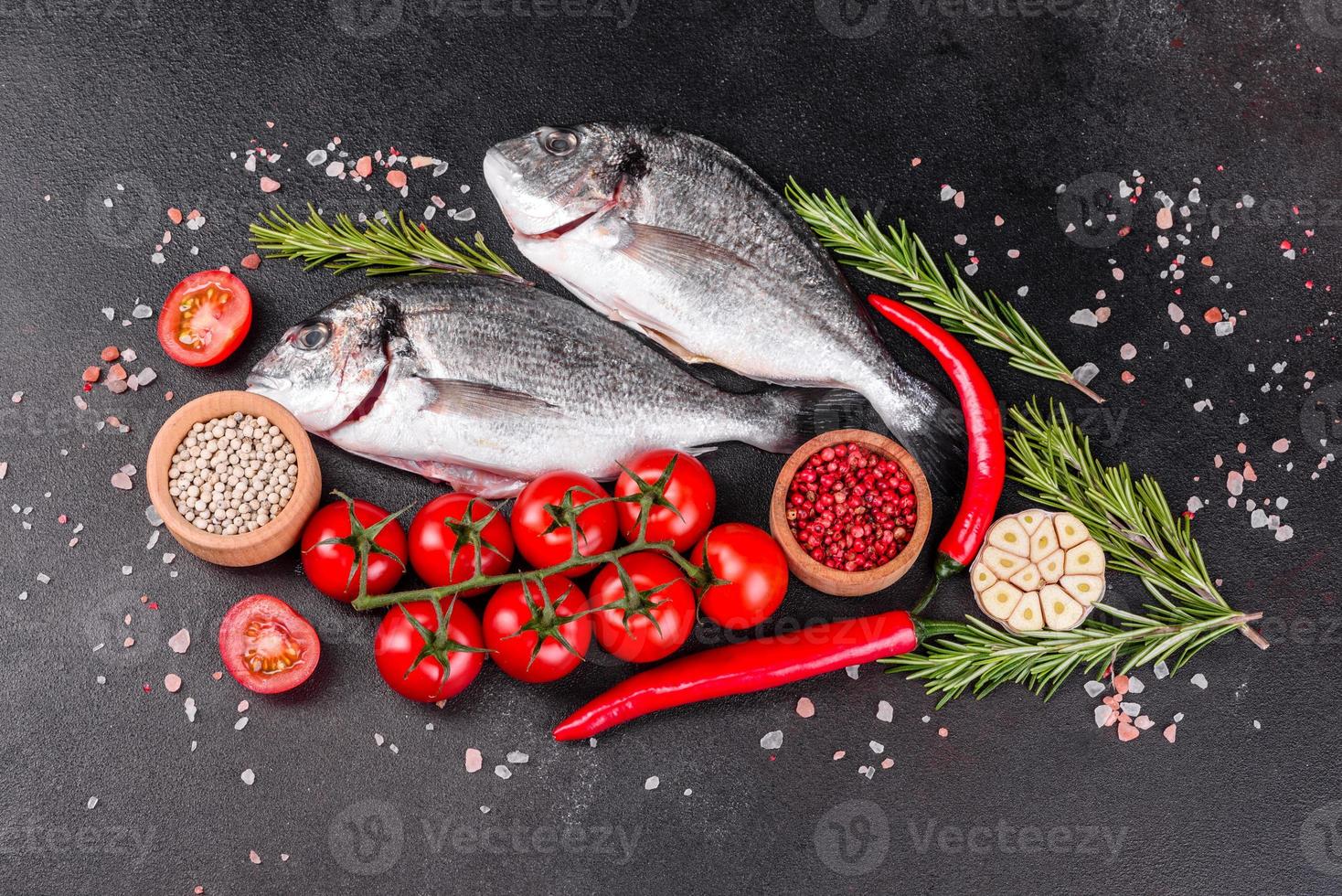 Raw dorado fish with spices cooking on cutting board photo