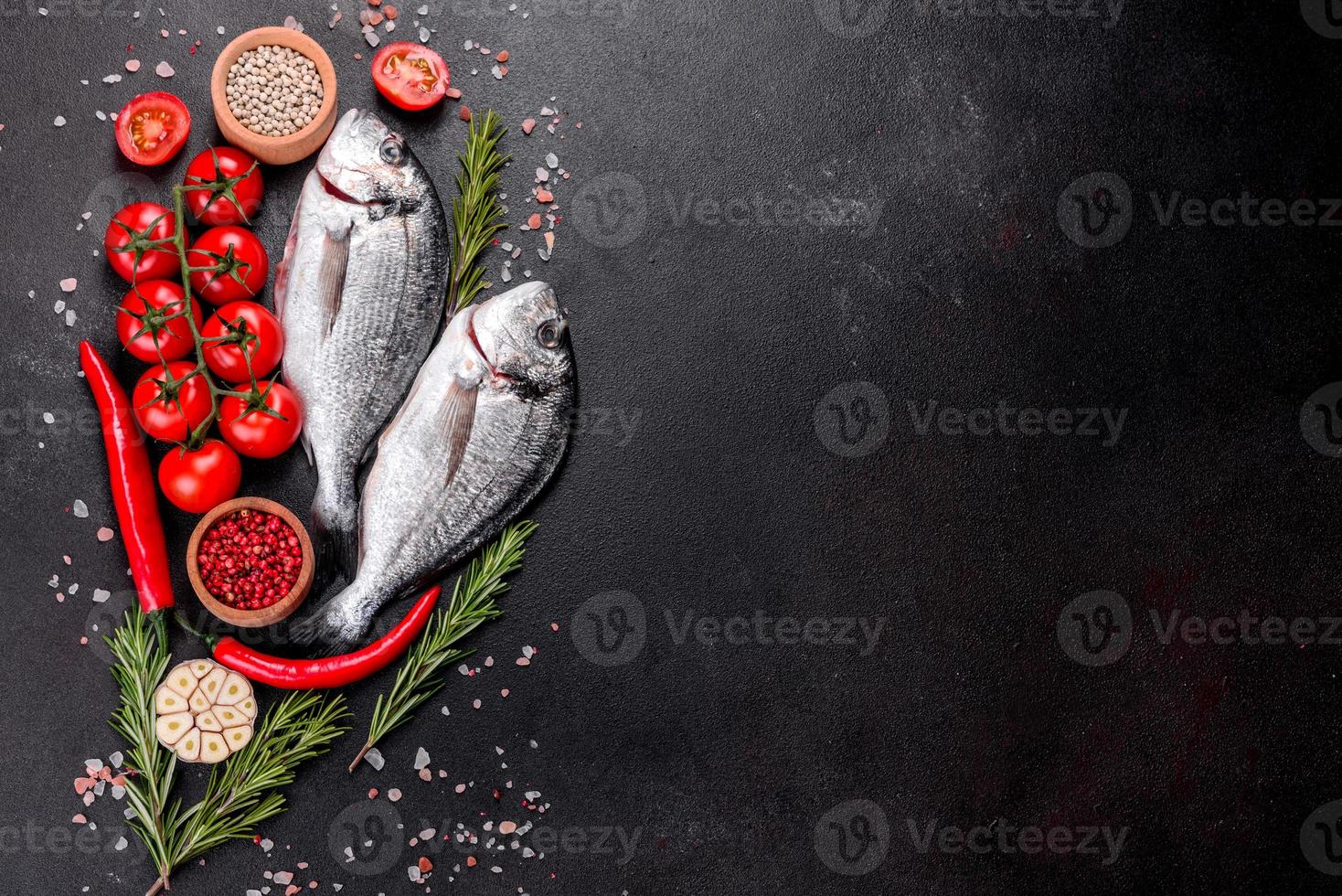 Raw dorado fish with spices cooking on cutting board photo