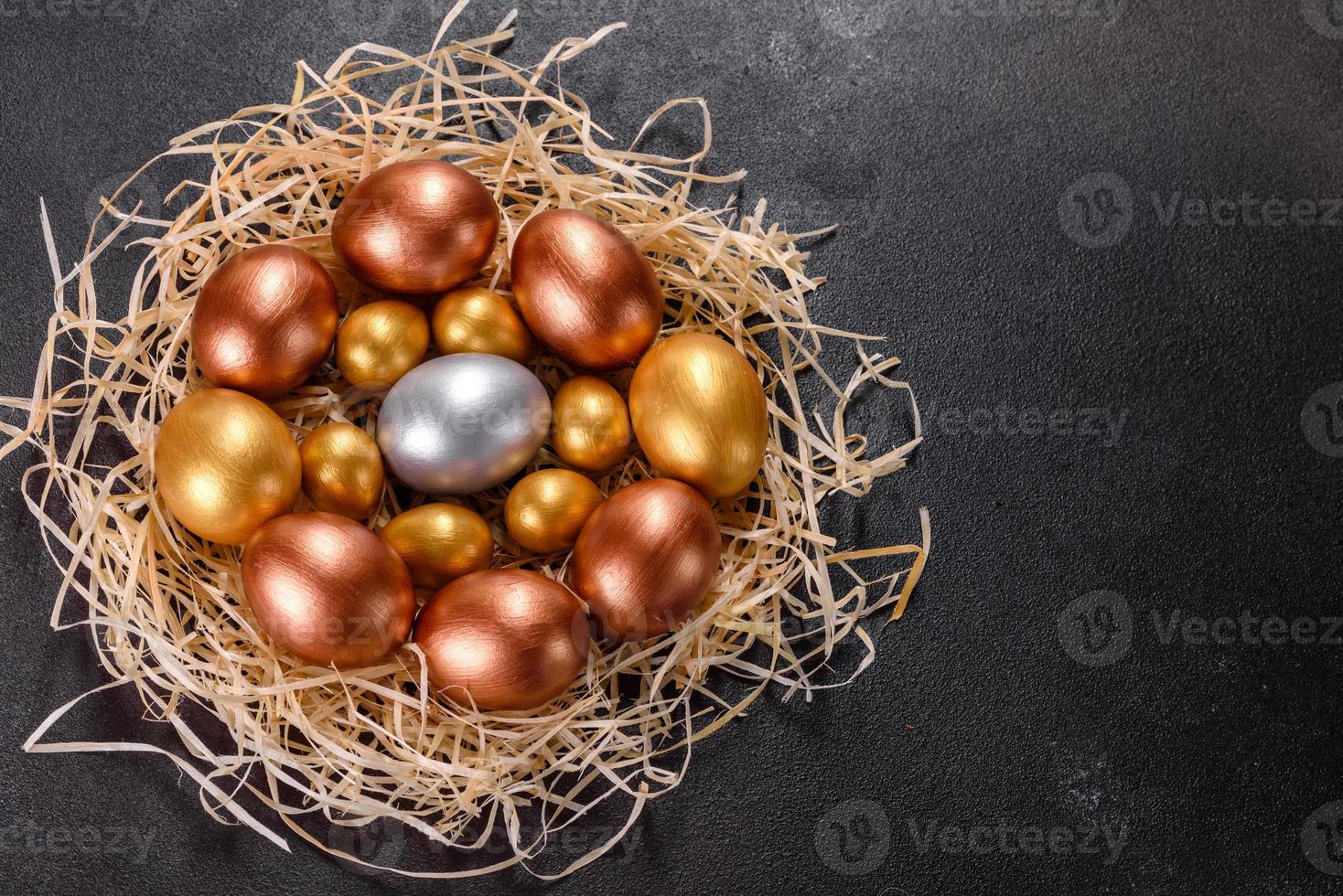 Easter golden eggs in the nest, preparation for the holiday photo