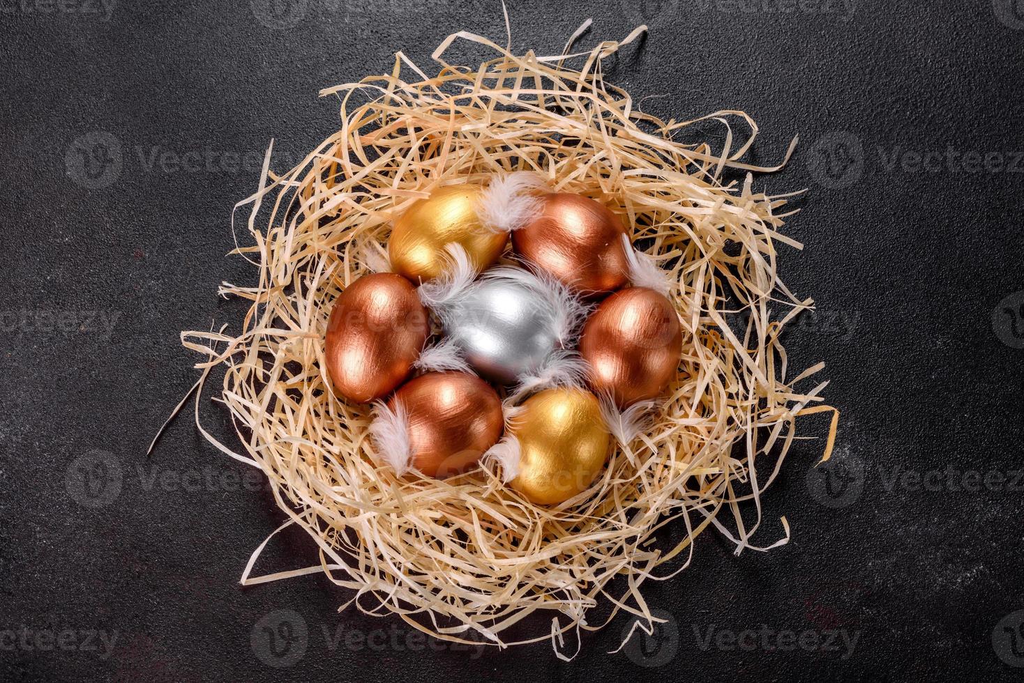 Easter golden eggs in the nest, preparation for the holiday photo