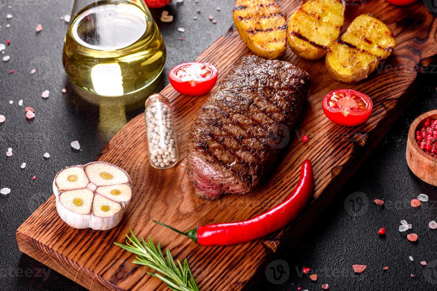 Ribeye steak with potatoes, onions and cherry tomatoes photo