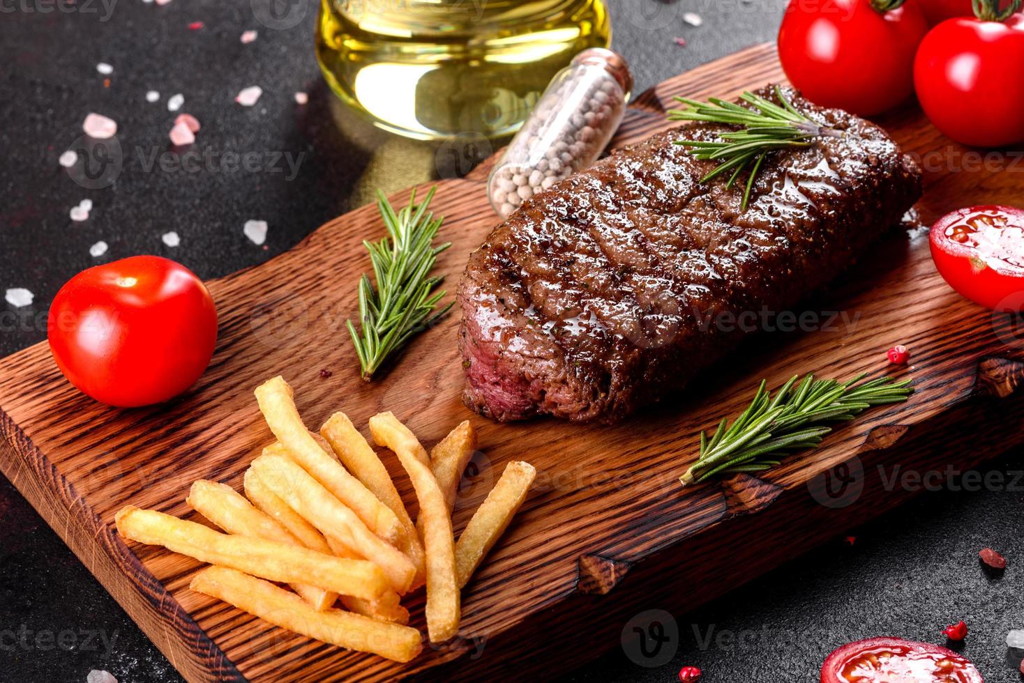 Ribeye steak with potatoes, onions and cherry tomatoes photo