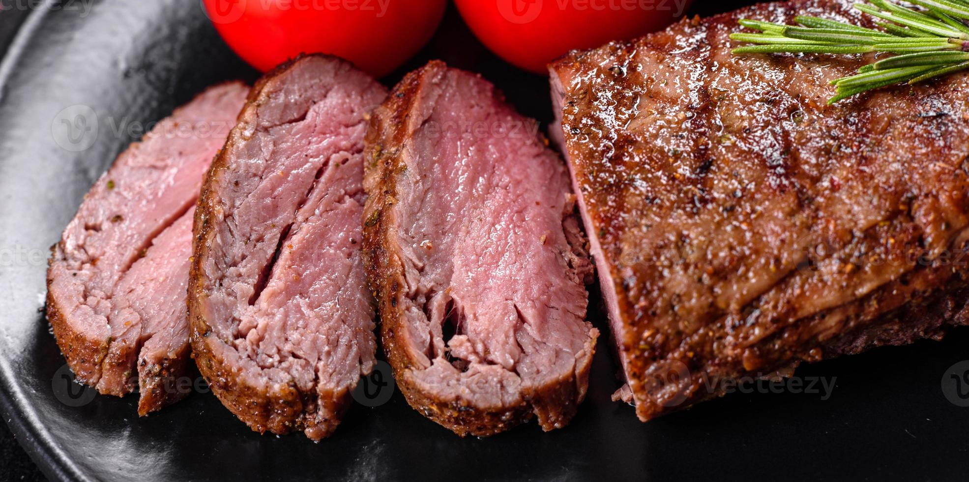 Ribeye steak with potatoes, onions and cherry tomatoes photo