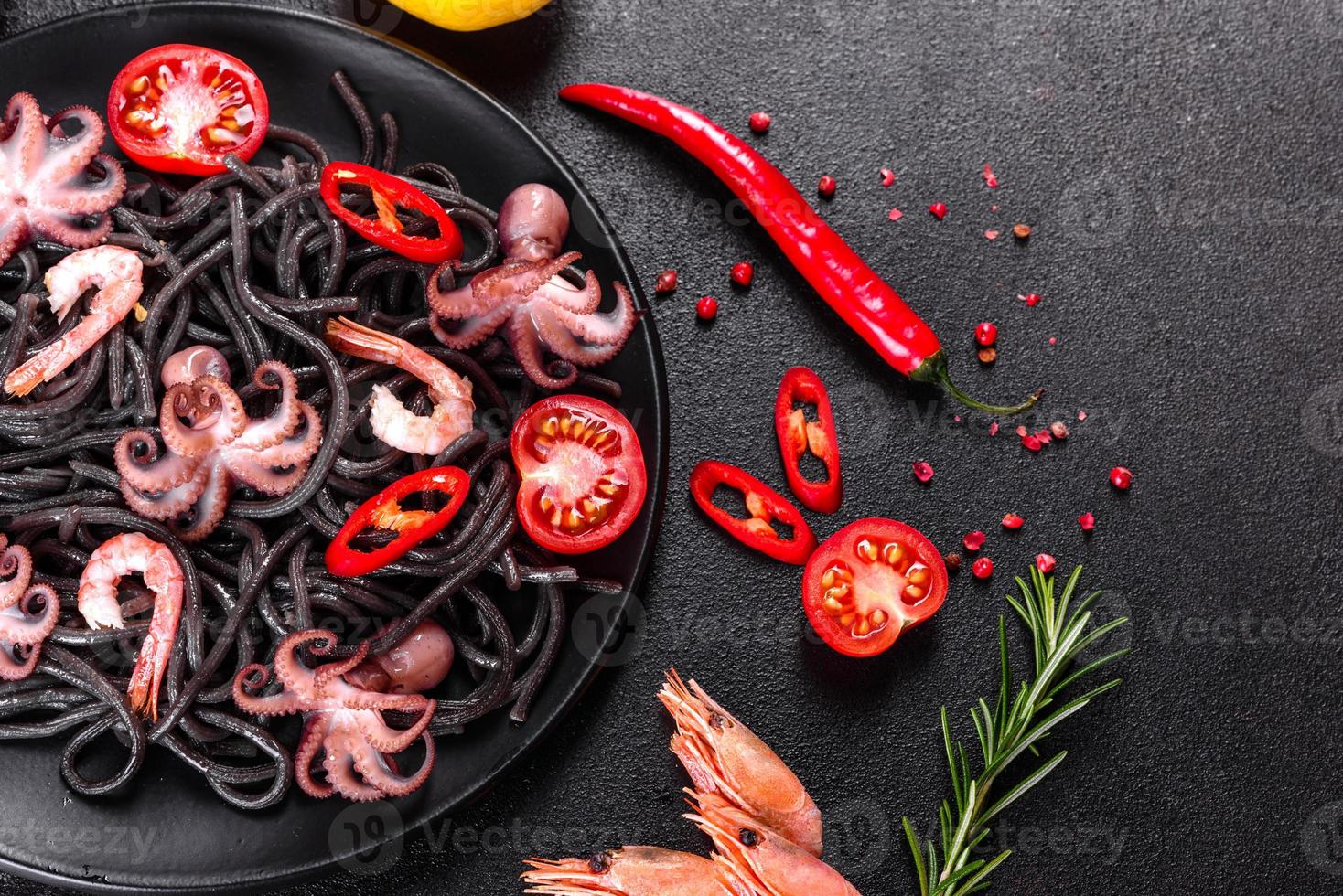 Black seafood pasta with shrimp, octopus and mussels photo