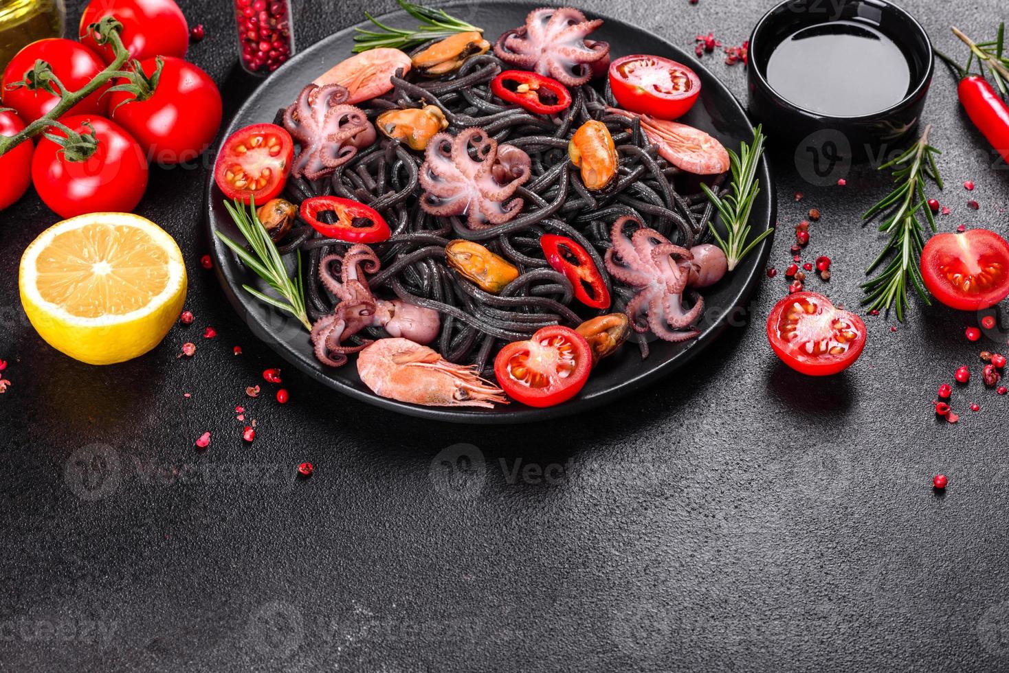 Black seafood pasta with shrimp, octopus and mussels photo