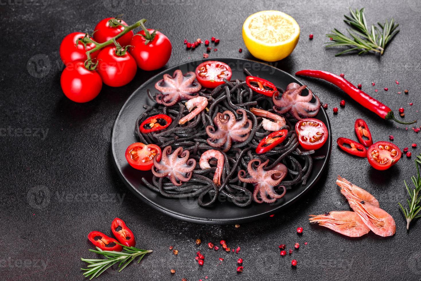 Black seafood pasta with shrimp, octopus and mussels photo