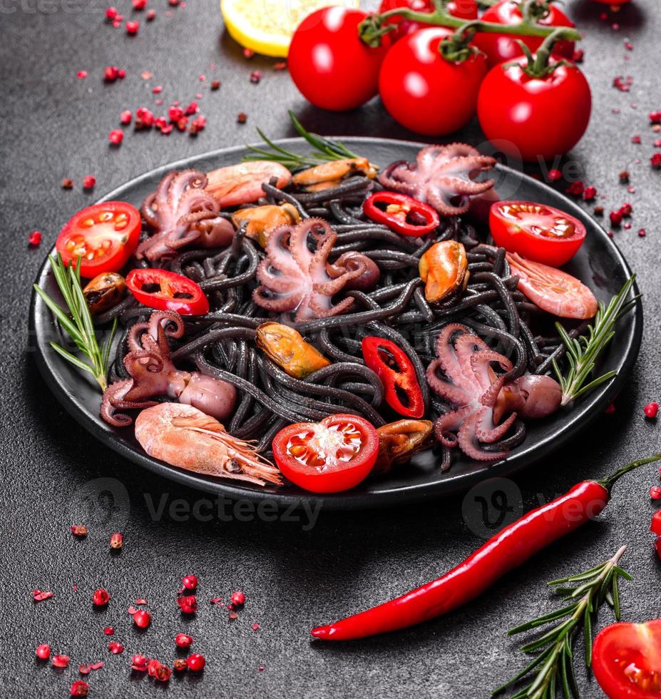 Black seafood pasta with shrimp, octopus and mussels photo