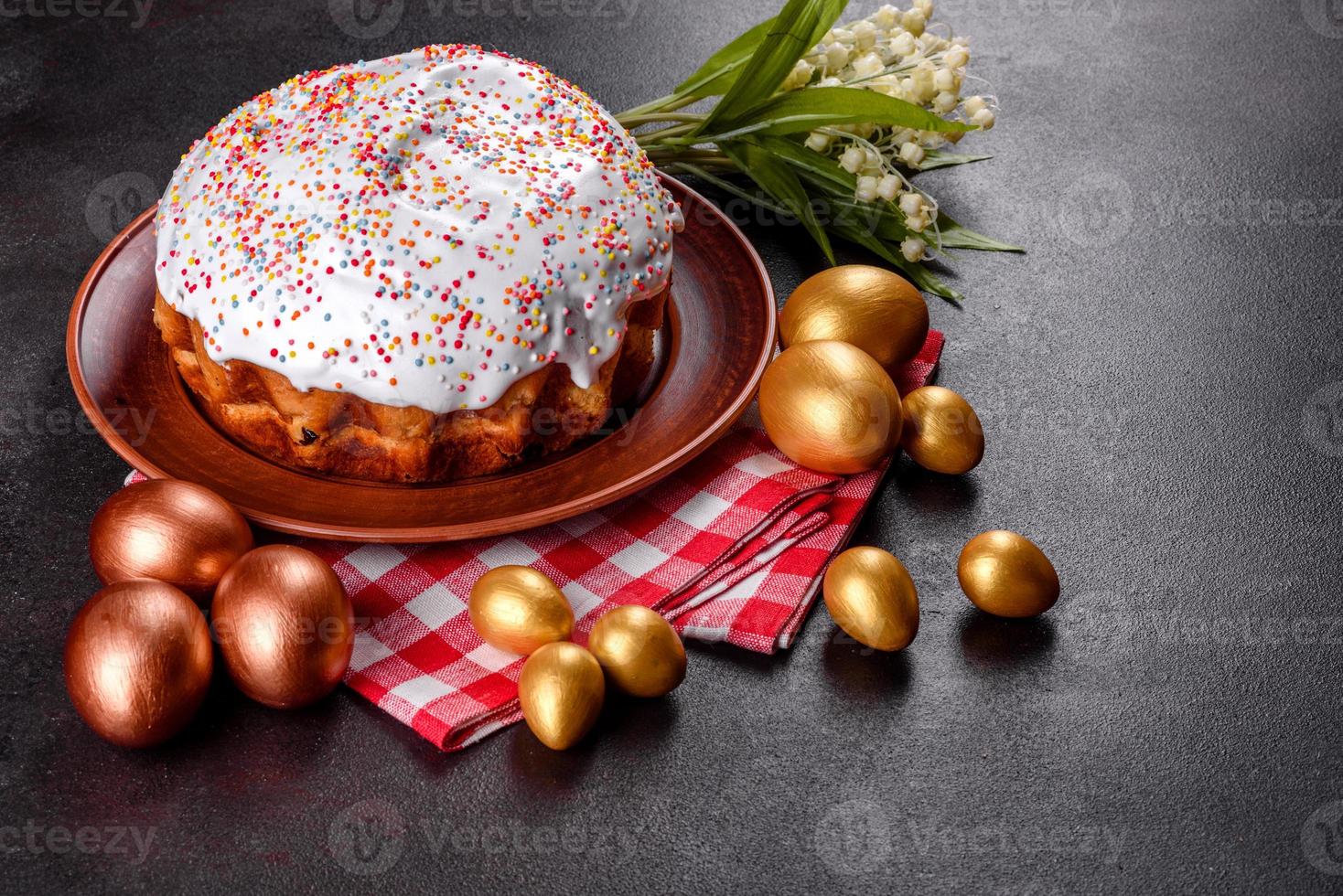 Easter eggs gold and bronze and Easter cake on a dark background photo