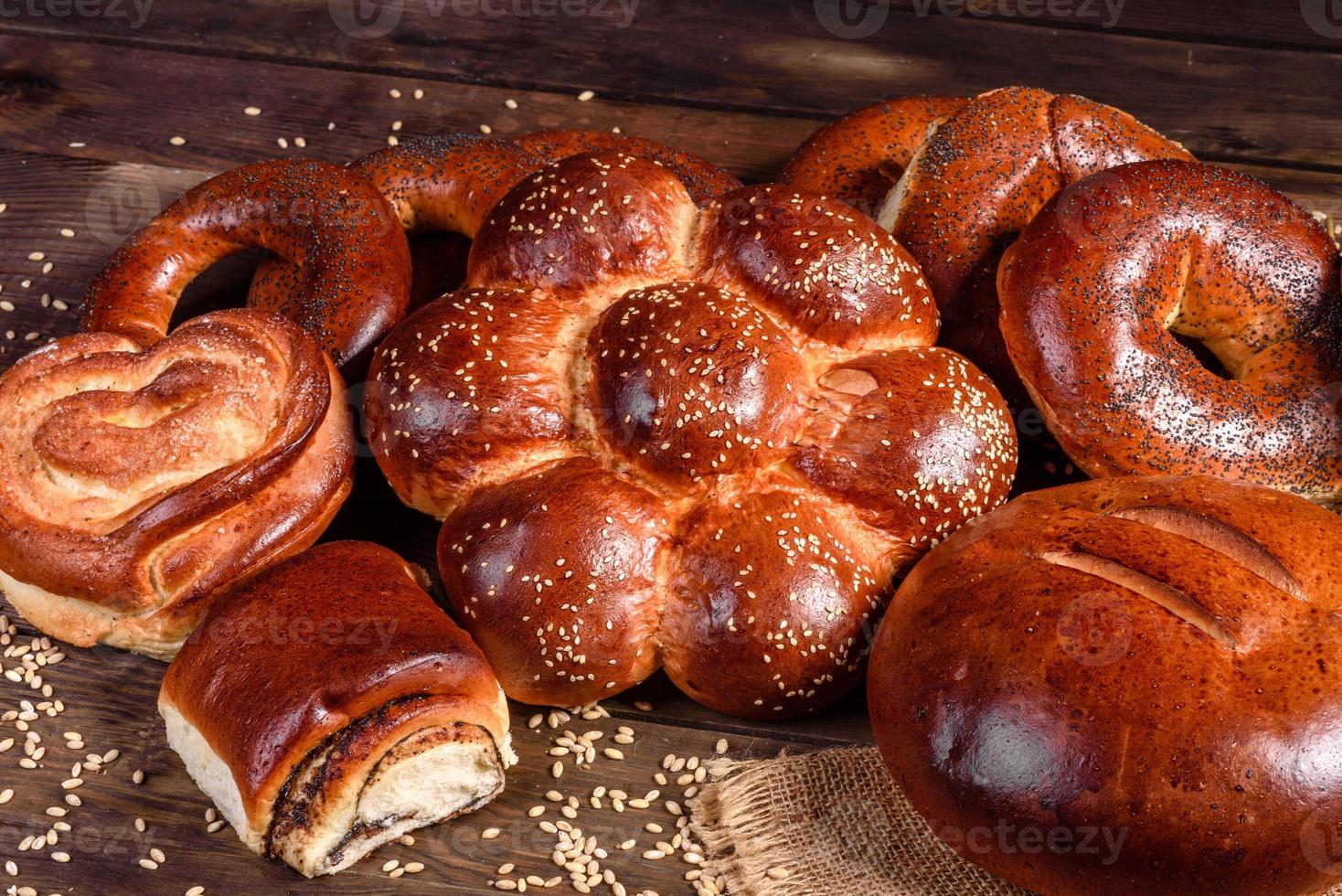 Composition of fresh baked sweet buns with poppy and jam photo