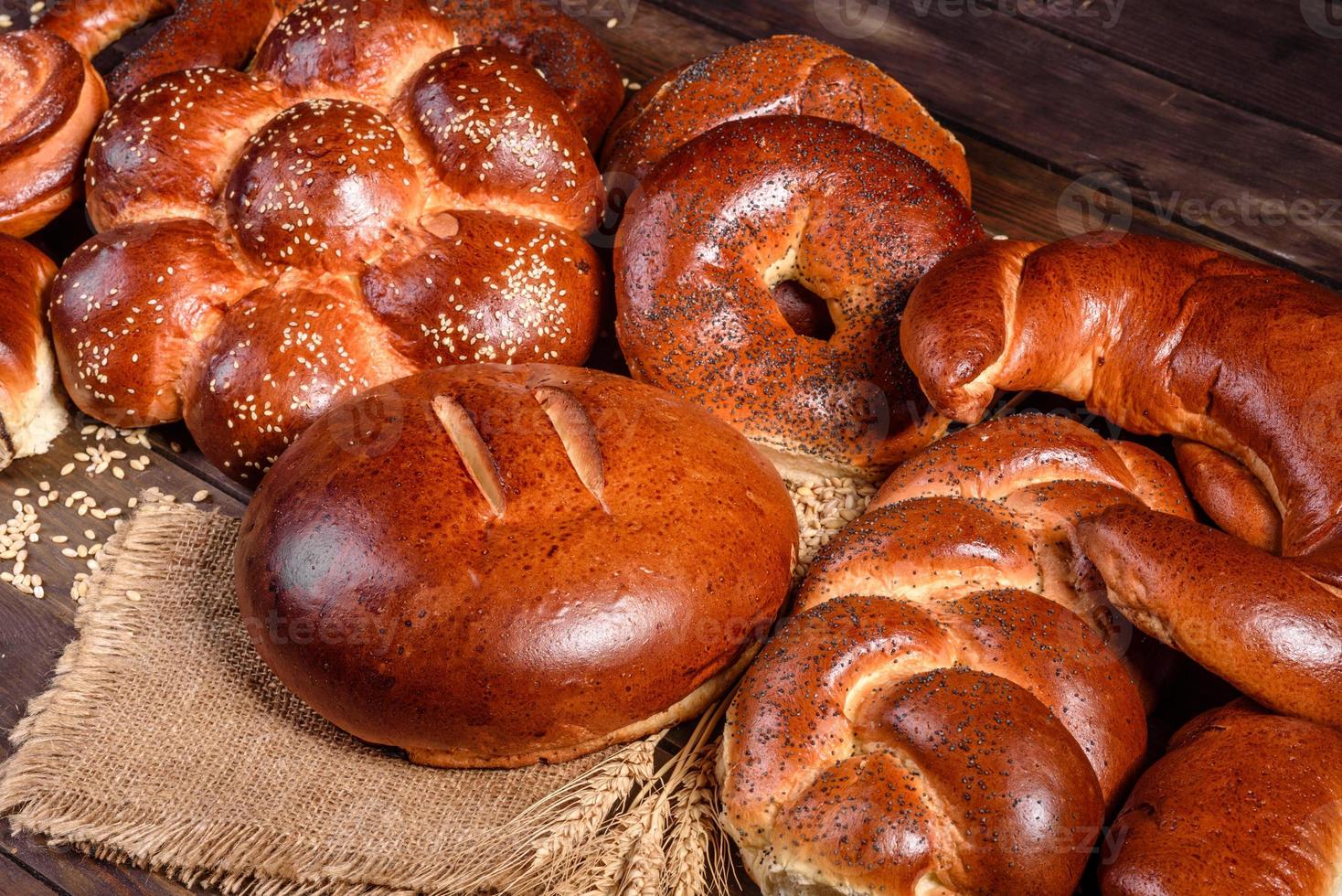 Composition of fresh baked sweet buns with poppy and jam photo