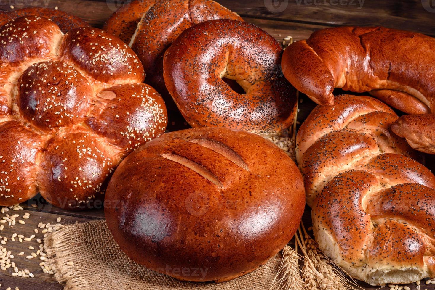 Composition of fresh baked sweet buns with poppy and jam photo