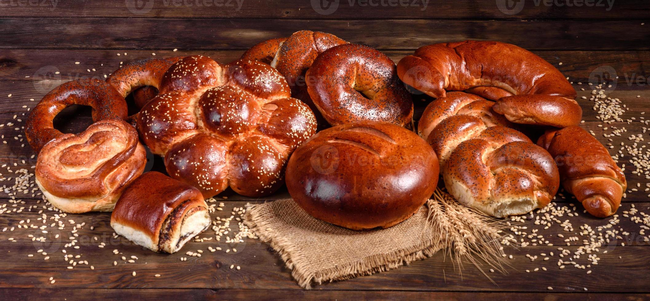 Composition of fresh baked sweet buns with poppy and jam photo