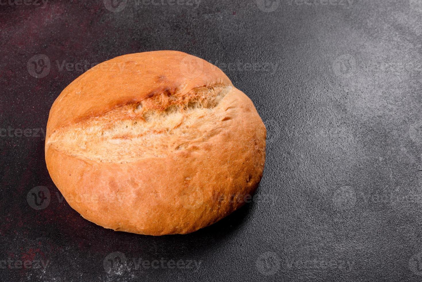 Fresh baked white bread on a brown concrete background photo