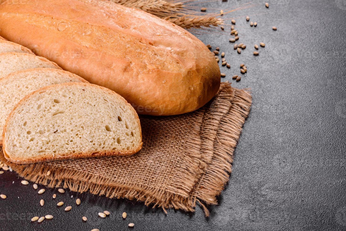 Fresh baked white bread on a brown concrete background photo