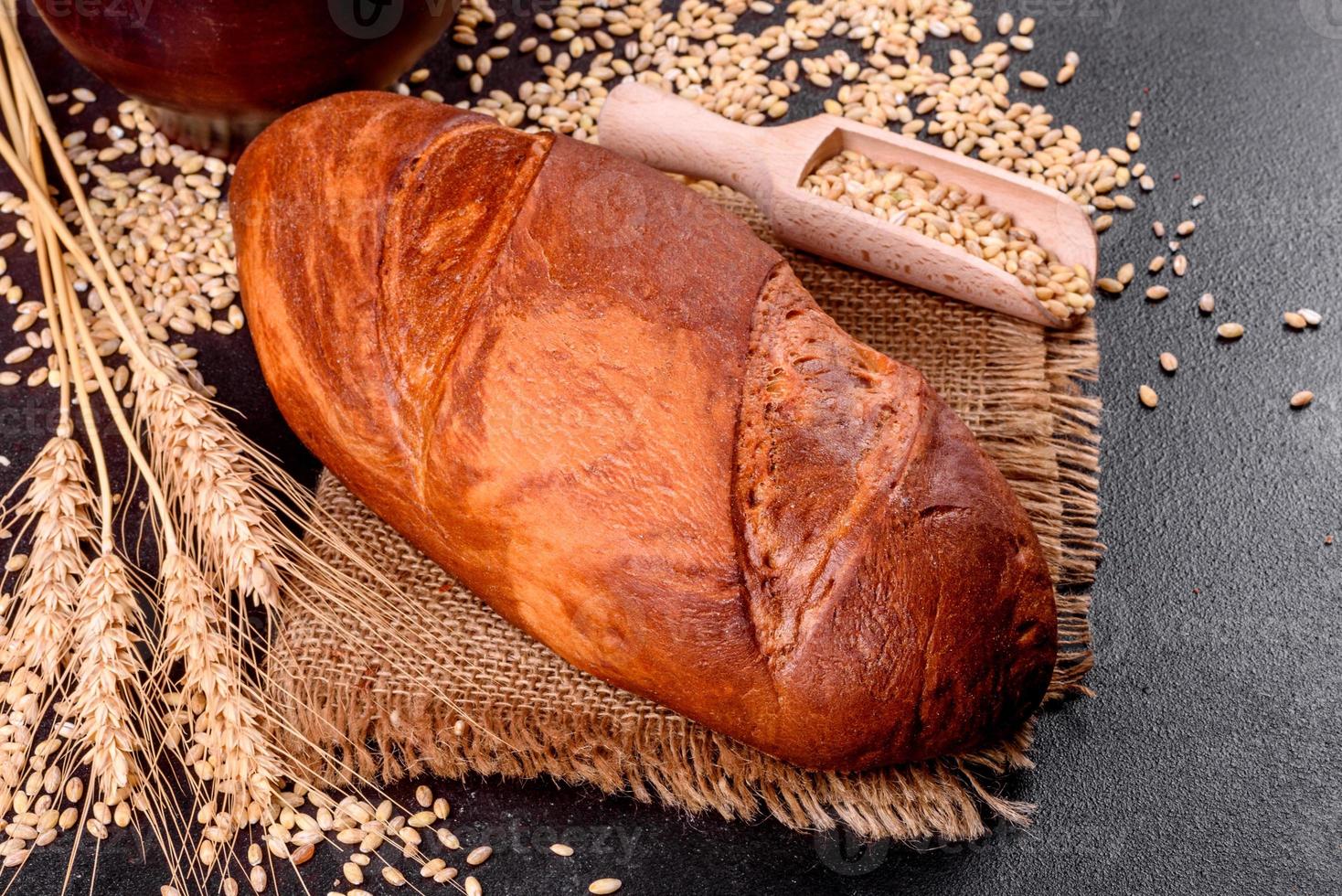 Fresh baked brown bread on a brown concrete background photo