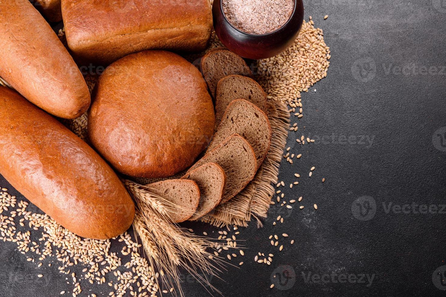 Fresh baked brown bread on a brown concrete background photo