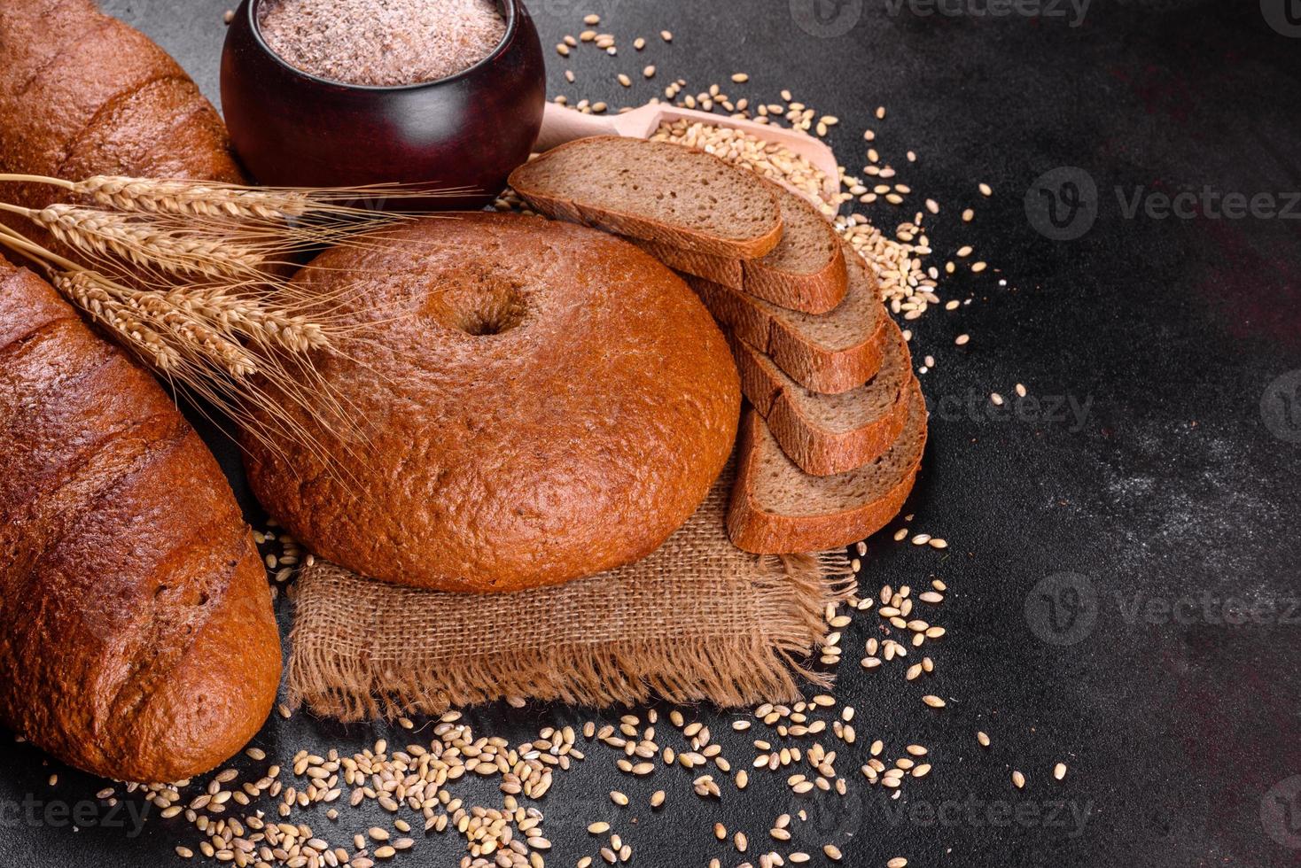 Fresh baked brown bread on a brown concrete background photo