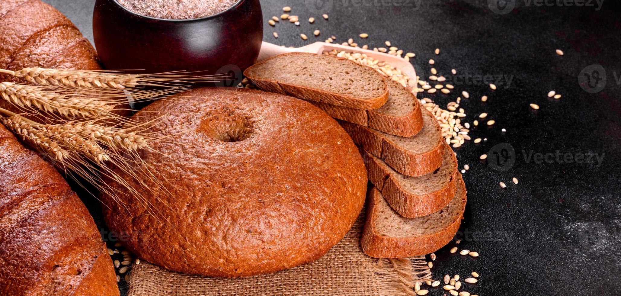 Fresh baked brown bread on a brown concrete background photo