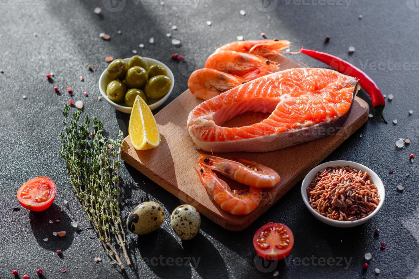 Raw trout red fish steak served with herbs and lemon photo