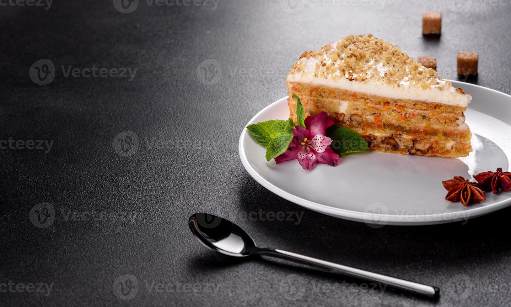 Fresh delicious carrot cake with cream on a dark background photo