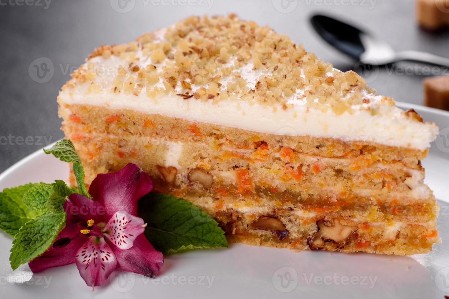 Fresh delicious carrot cake with cream on a dark background photo