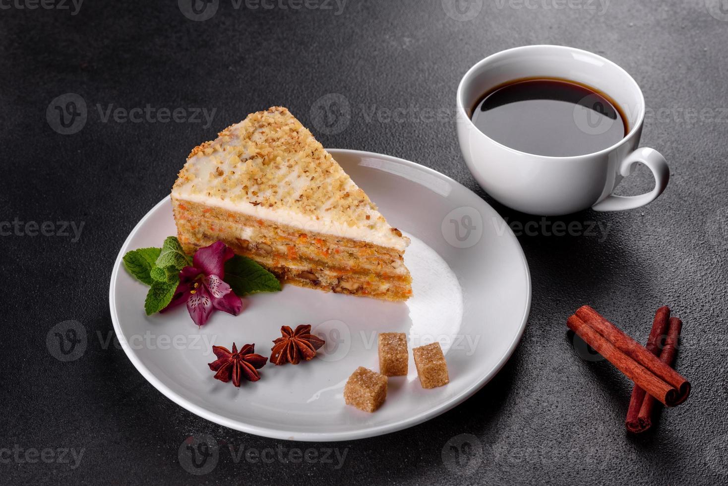 Fresh delicious carrot cake with cream on a dark background photo