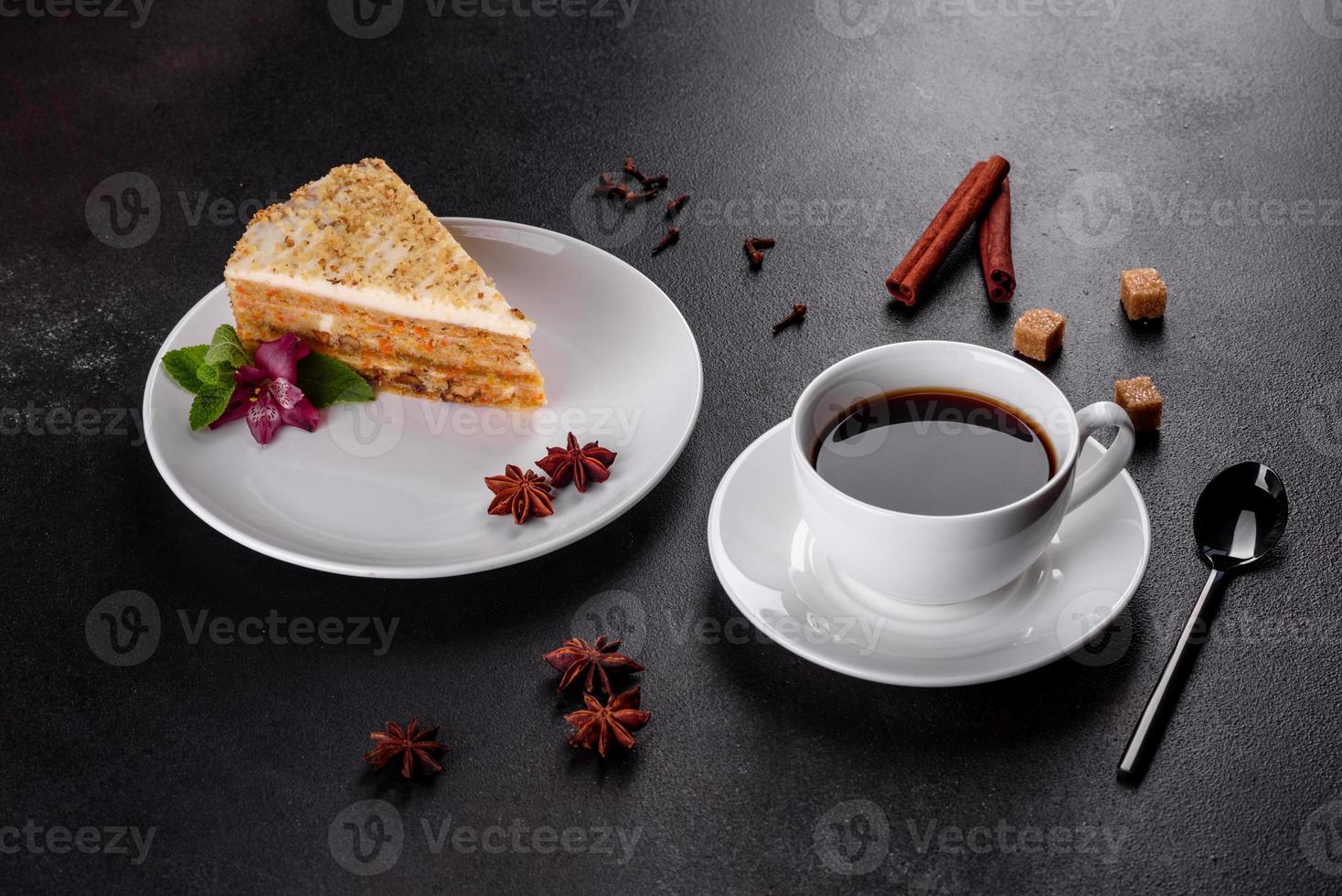 Fresh delicious carrot cake with cream on a dark background photo