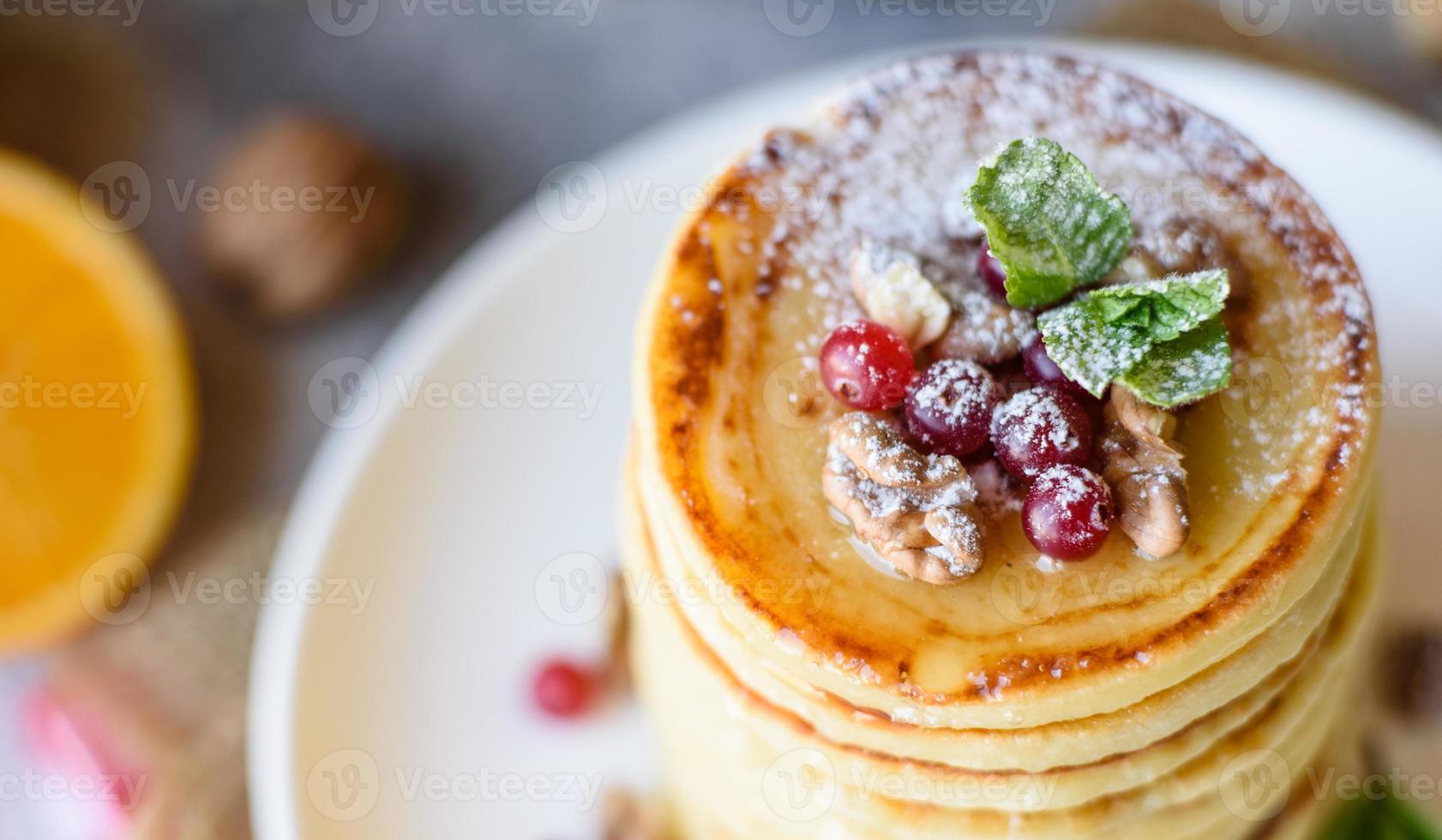 Delicious fresh beautiful pancakes with citrus honey and jam photo