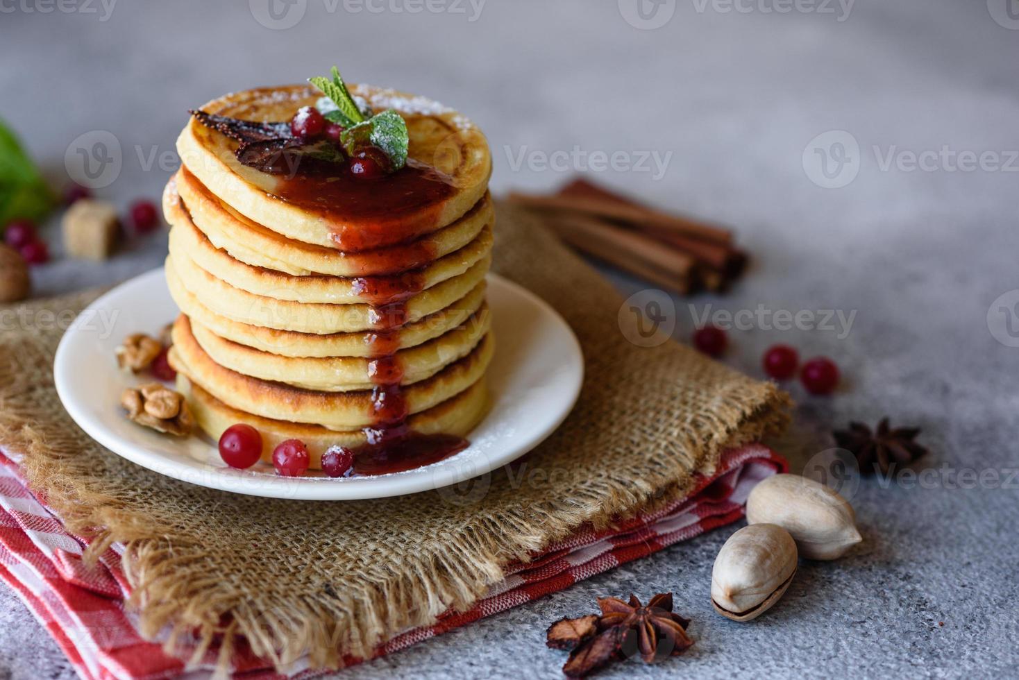 Delicious fresh beautiful pancakes with citrus honey and jam photo