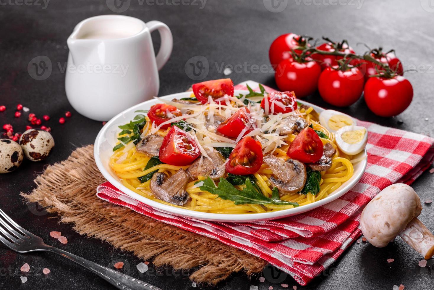 Spaghetti with mushrooms, cheese, spinach, rukkola and cherry tomatoes photo