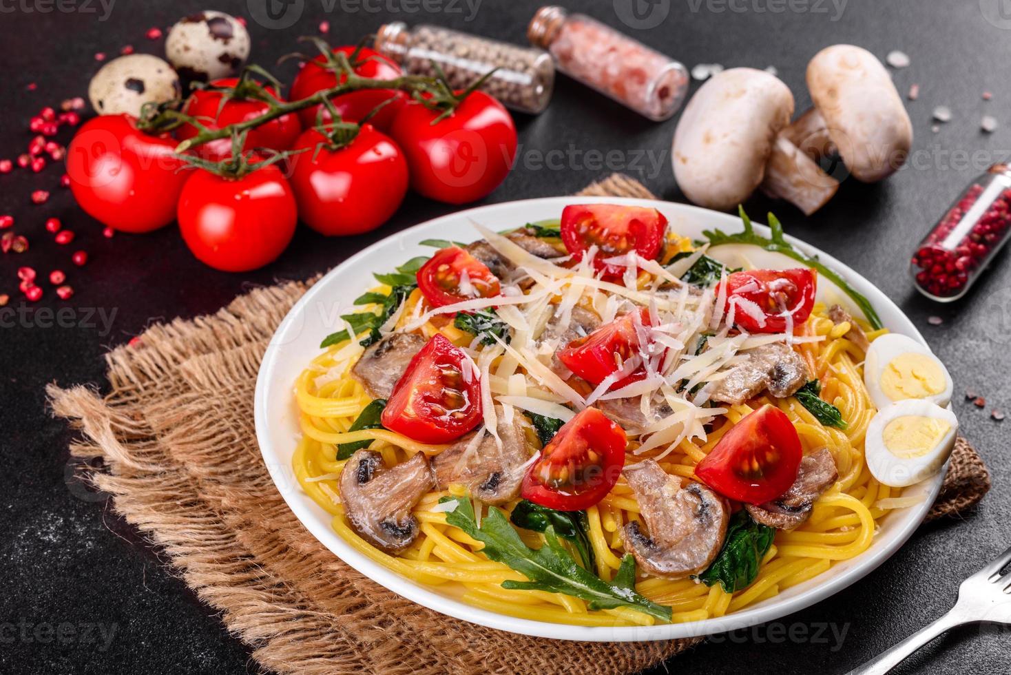 Spaghetti with mushrooms, cheese, spinach, rukkola and cherry tomatoes photo