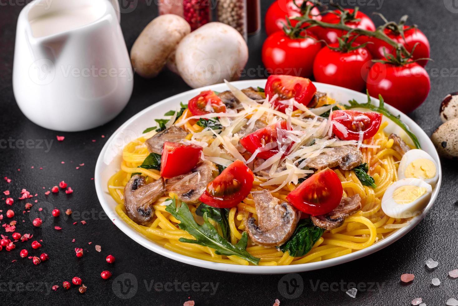 Spaghetti with mushrooms, cheese, spinach, rukkola and cherry tomatoes photo