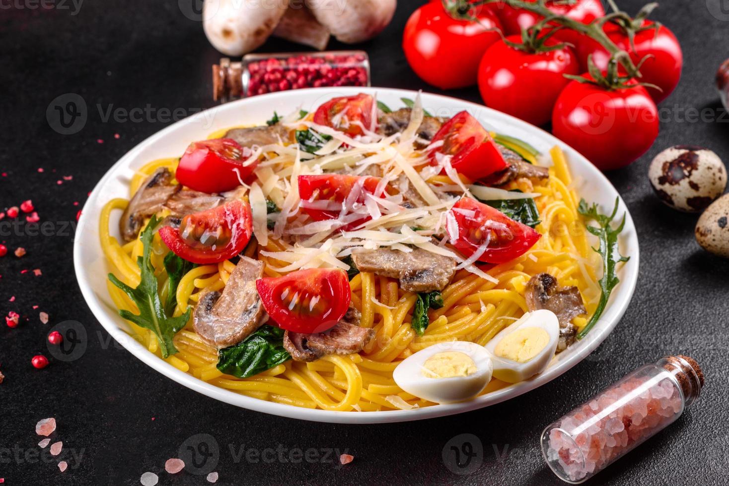 Spaghetti with mushrooms, cheese, spinach, rukkola and cherry tomatoes photo