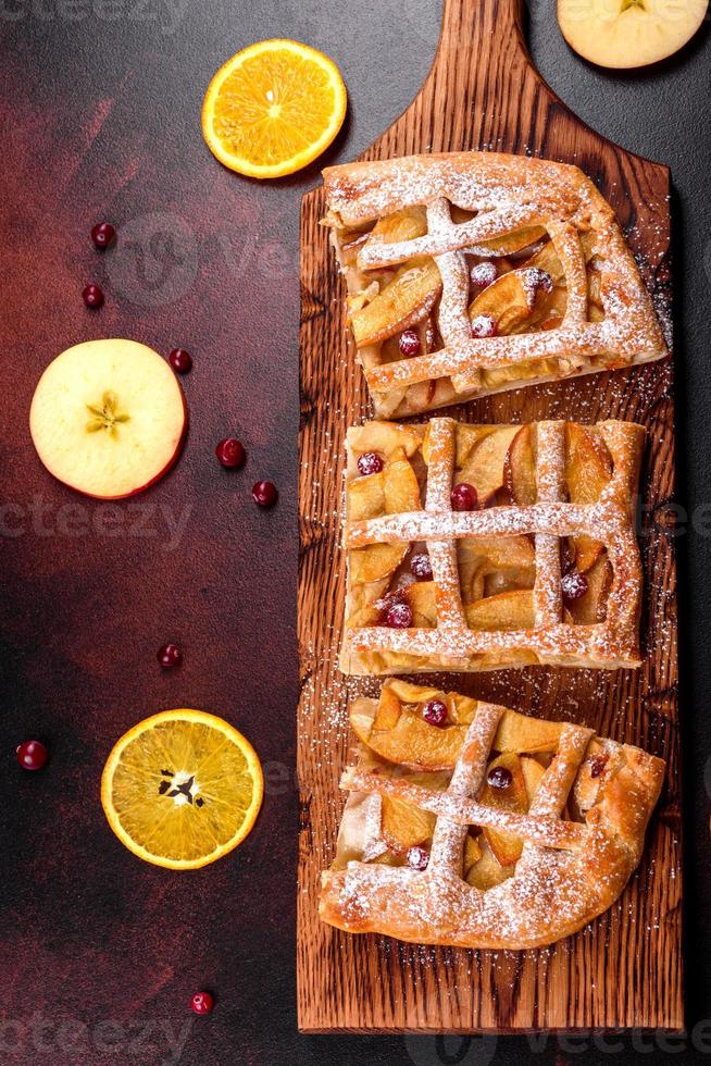 Delicious fresh pie baked with apple, pears and berries photo