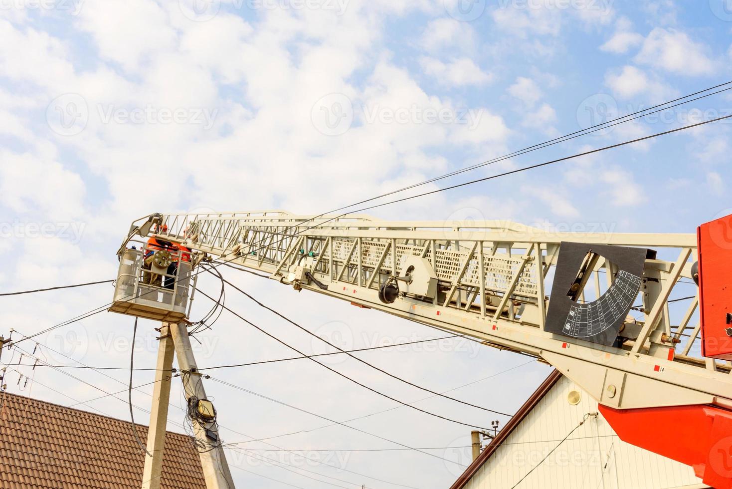 Boom of lifting wheel hydraulic crane with basket for workers photo