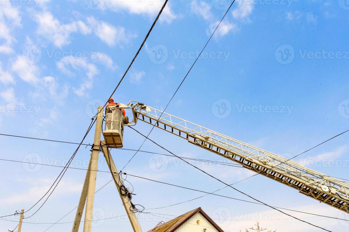 Boom of lifting wheel hydraulic crane with basket for workers photo