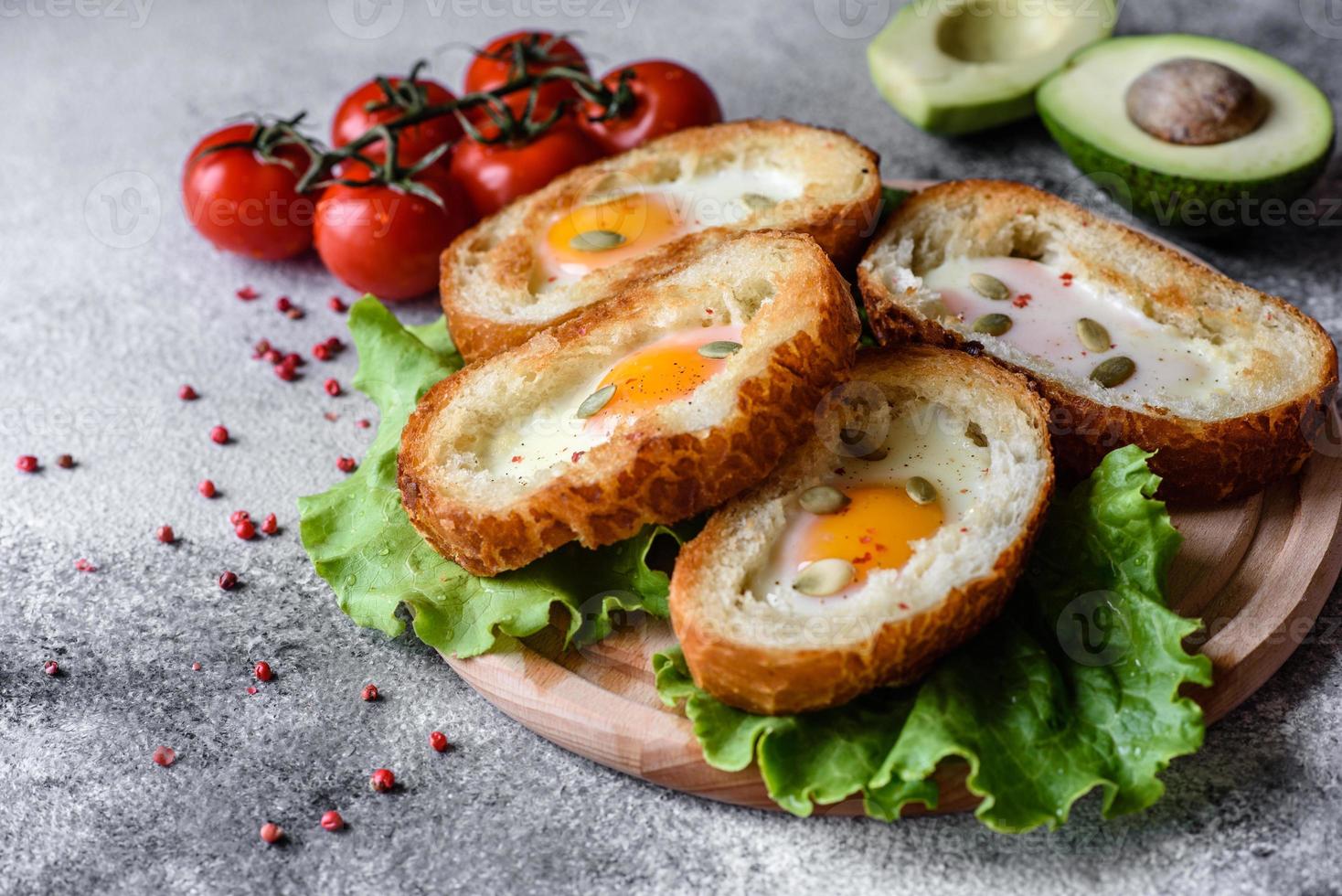 Delicious breakfast with grunts, eggs, avocado and cherry tomatoes photo