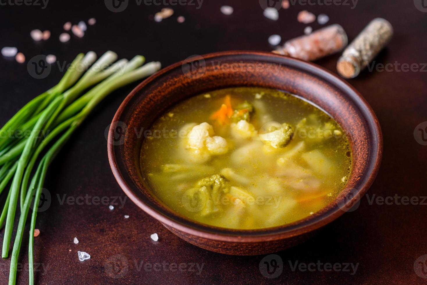 Fresh vegan soup with broccoli, cauliflower, asparagus and carrots photo