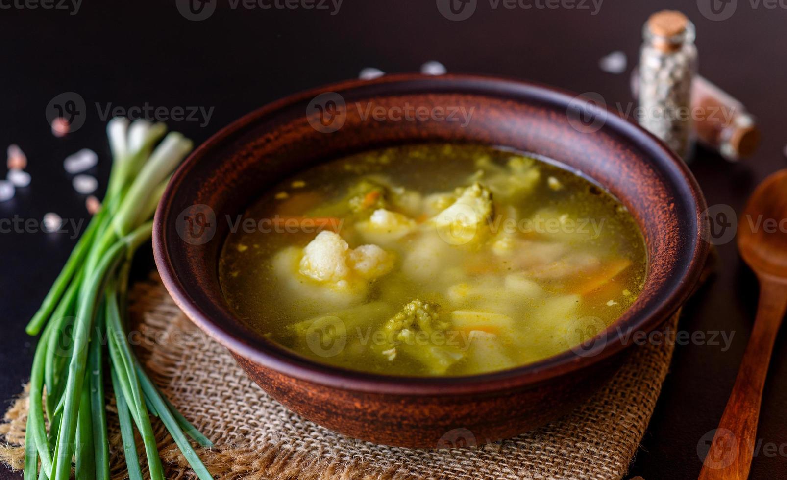 Fresh vegan soup with broccoli, cauliflower, asparagus and carrots photo