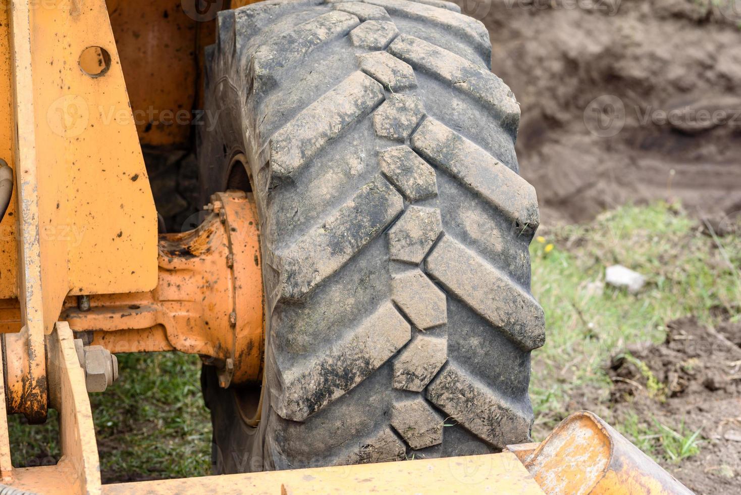 The modern excavator performs excavation work on the construction site photo