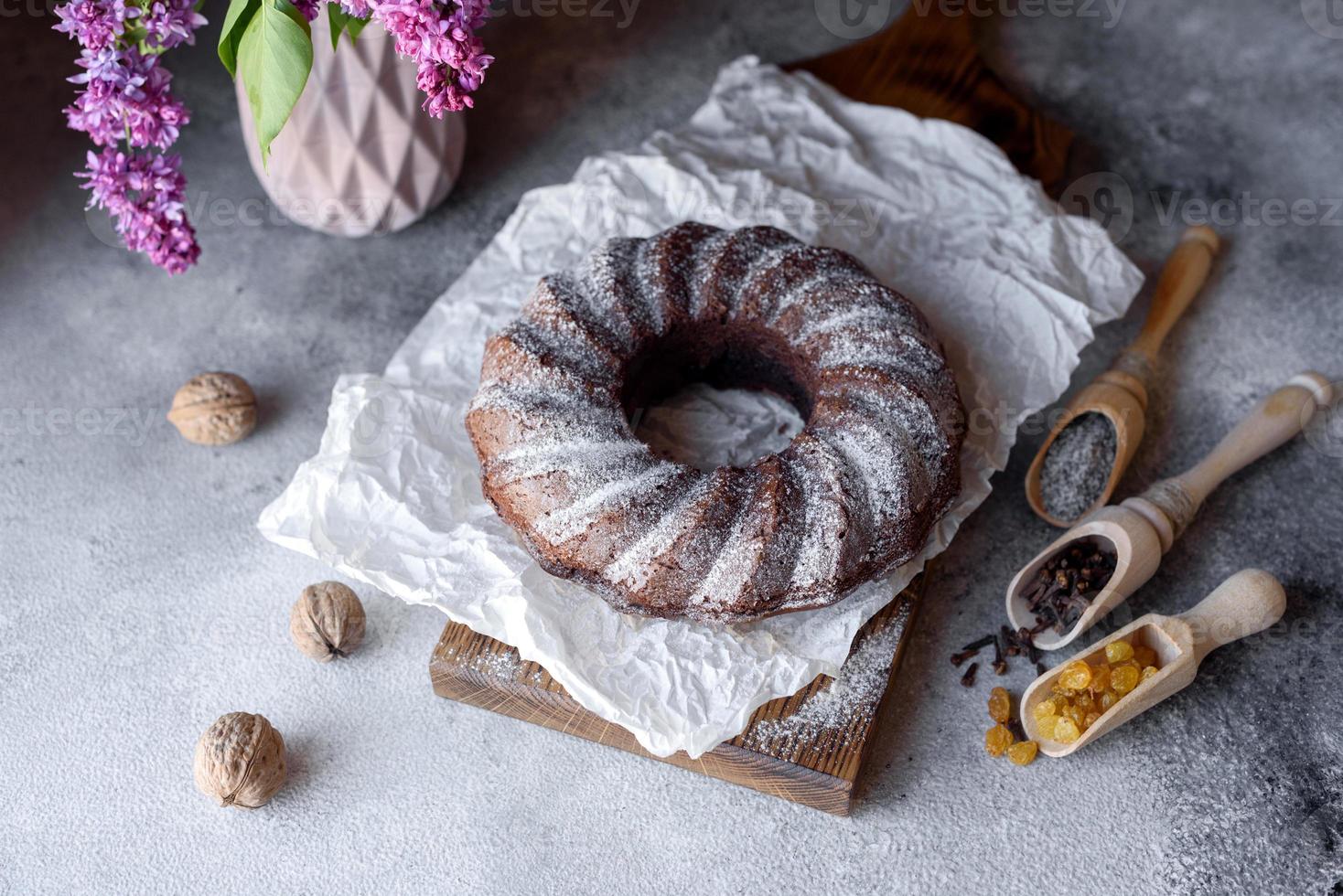 Round chocolate coffee cupcake with raisins and poppy photo