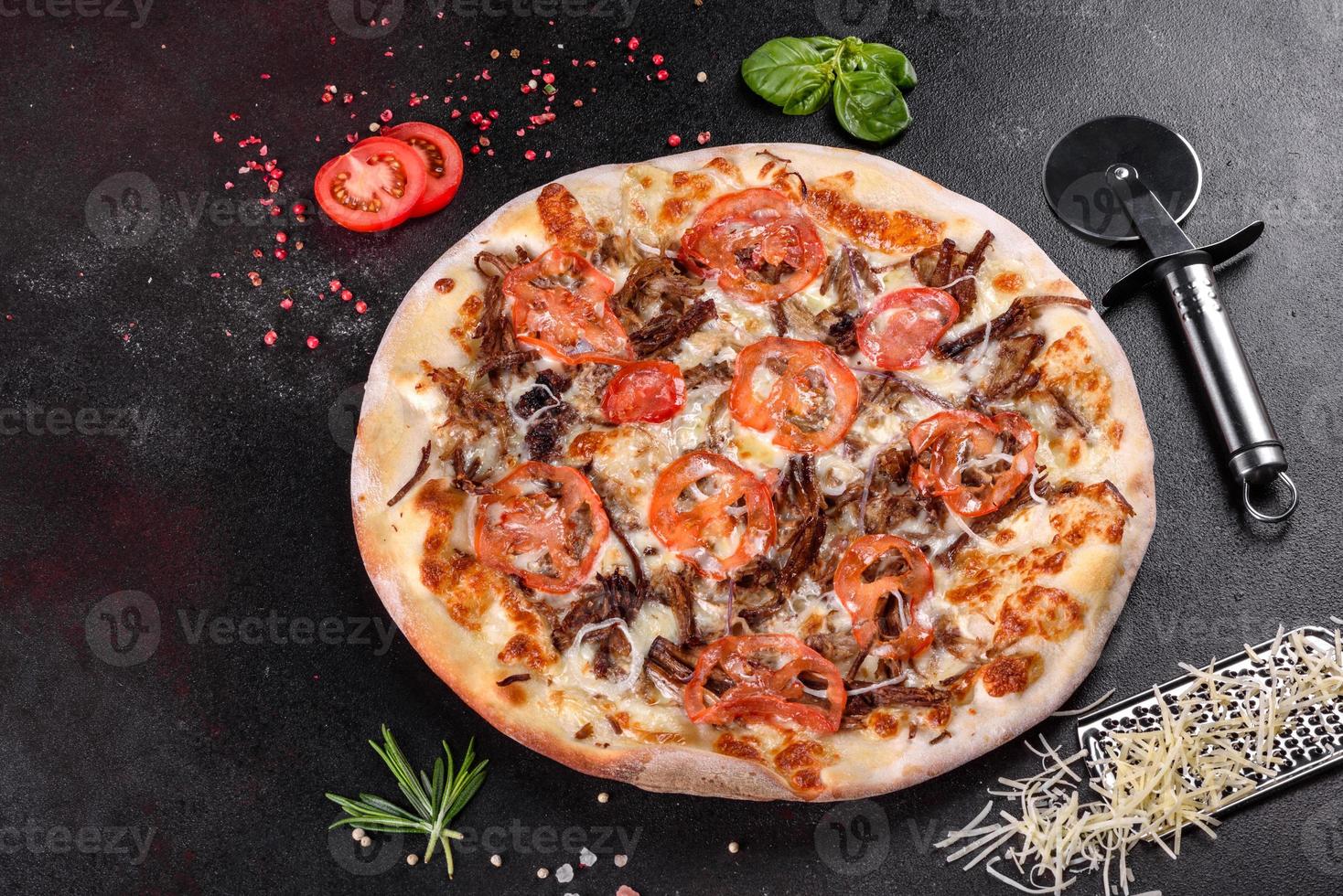 Fresh hot pizza with meat, mushrooms, cheese and tomatoes photo