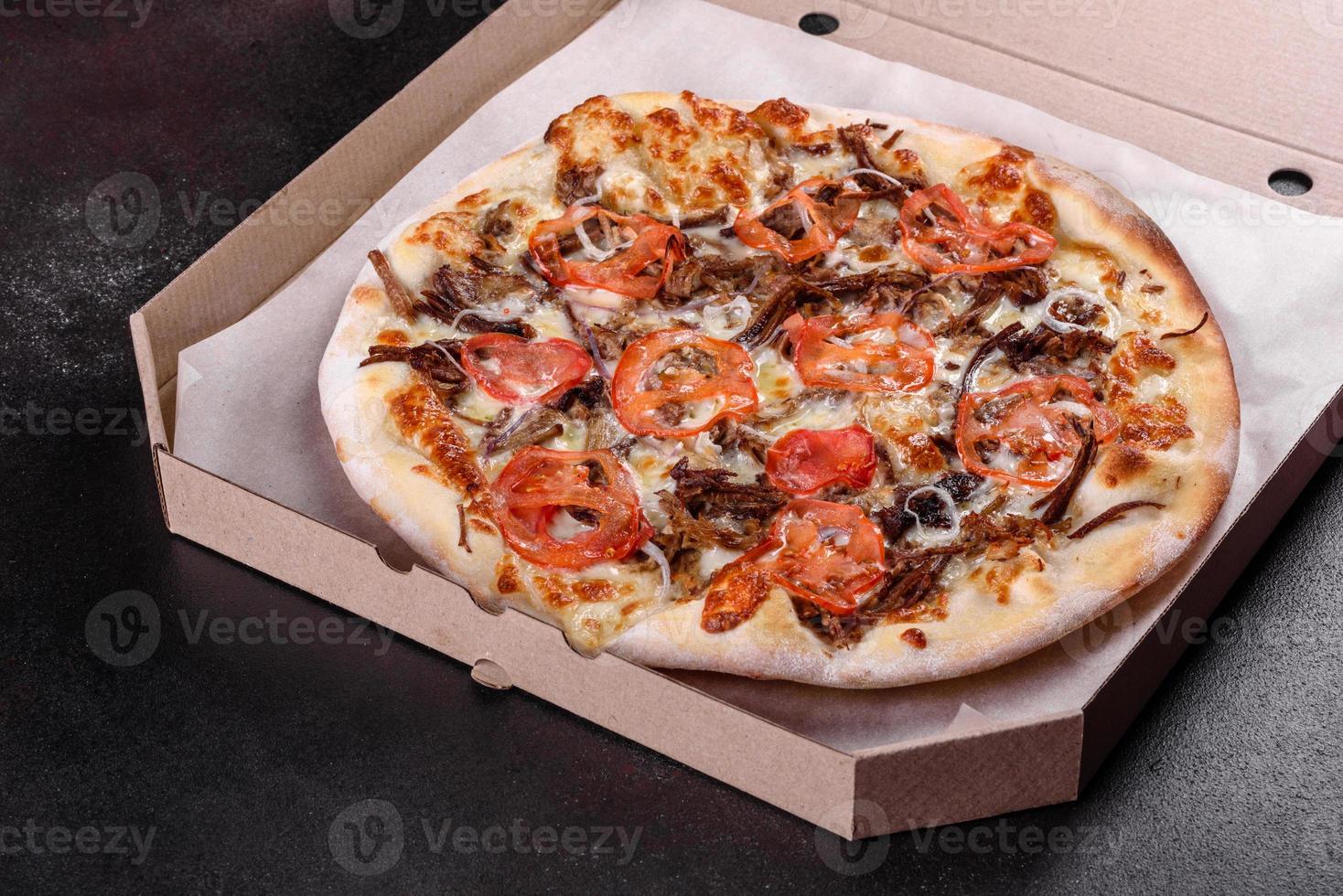 Fresh hot pizza with meat, mushrooms, cheese and tomatoes photo