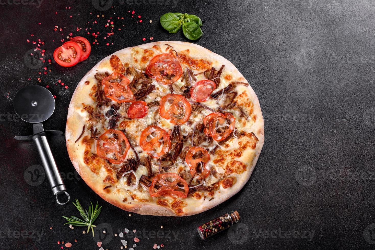 Fresh hot pizza with meat, mushrooms, cheese and tomatoes photo