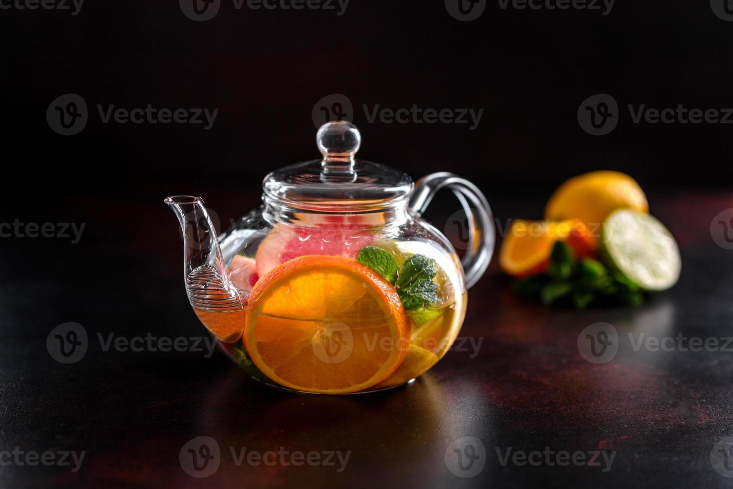 Hot fruit tea with lemon, mint, orange, lime and grapefruit photo