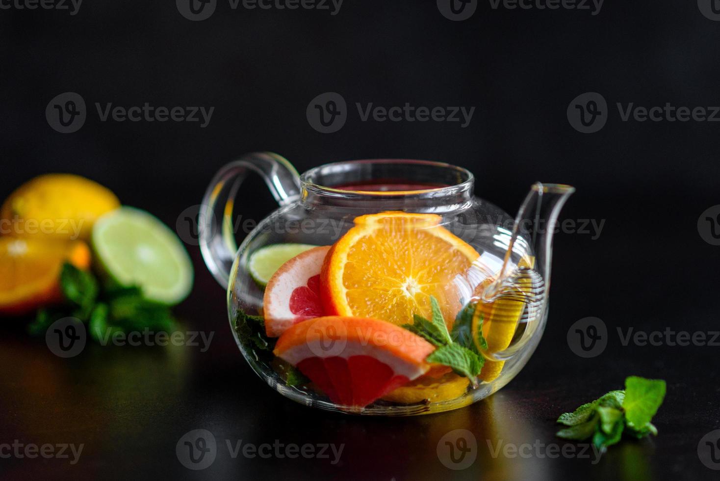 Hot fruit tea with lemon, mint, orange, lime and grapefruit photo