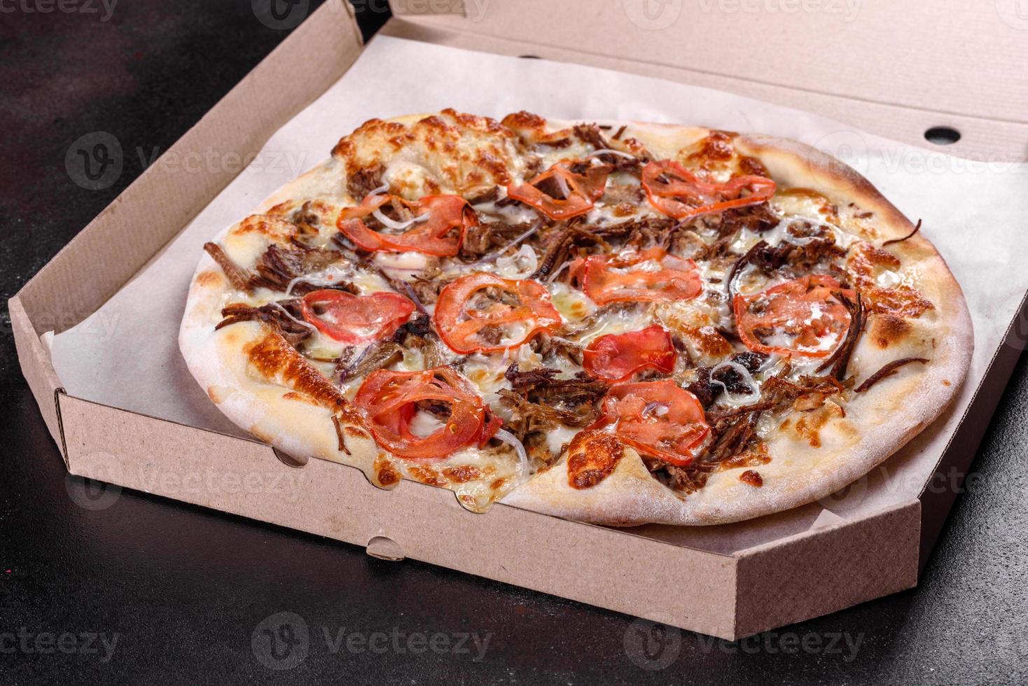 Fresh hot pizza with meat, mushrooms, cheese and tomatoes photo