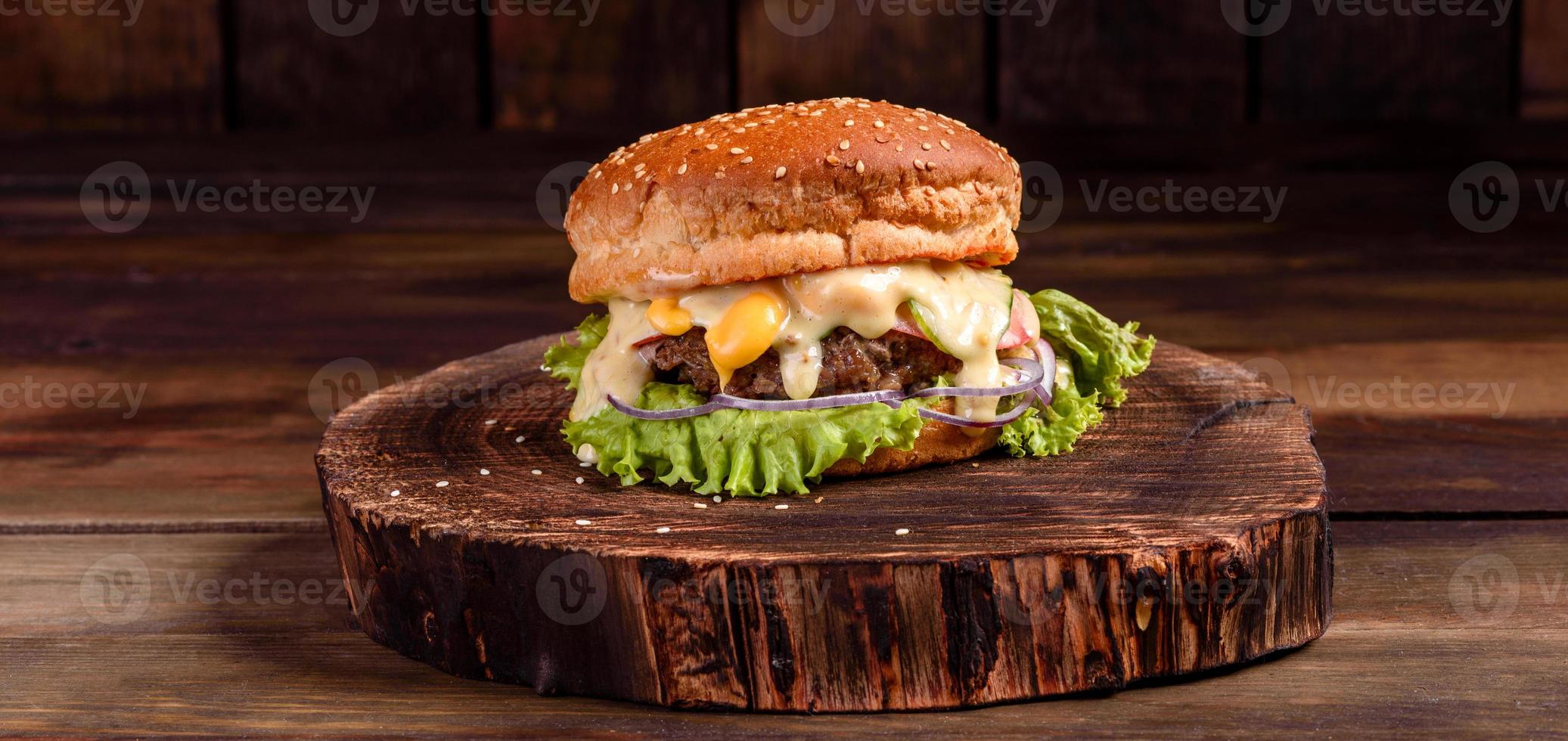 Tasty grilled homemade burger with beef, tomato, cheese photo